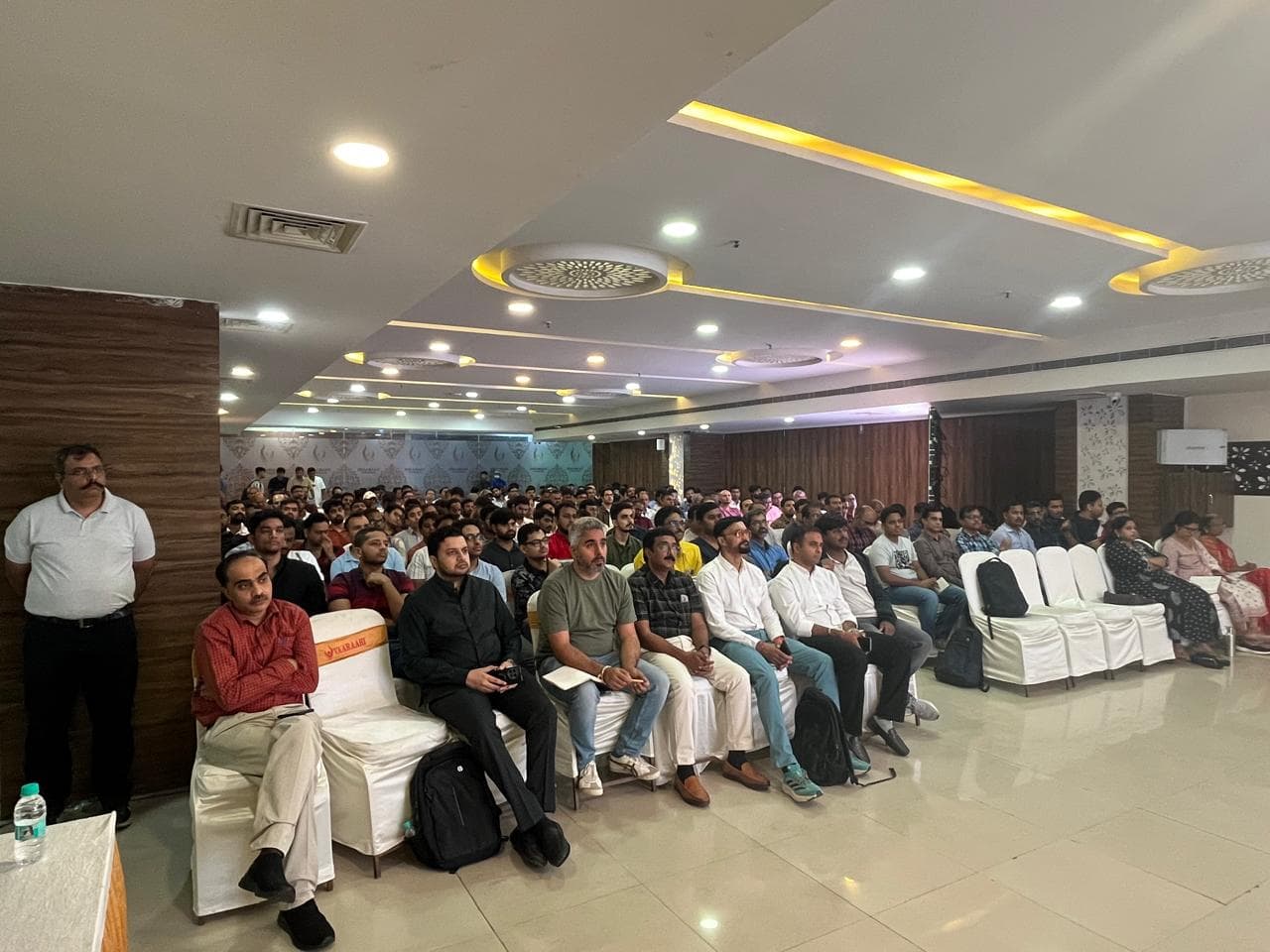 A hall of investors seated and listening to a session at an HIE meet